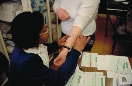 Nurse performing a TB skin test, UK